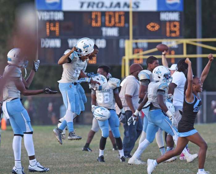 Players, coaches and cheerleaders celebrating the win